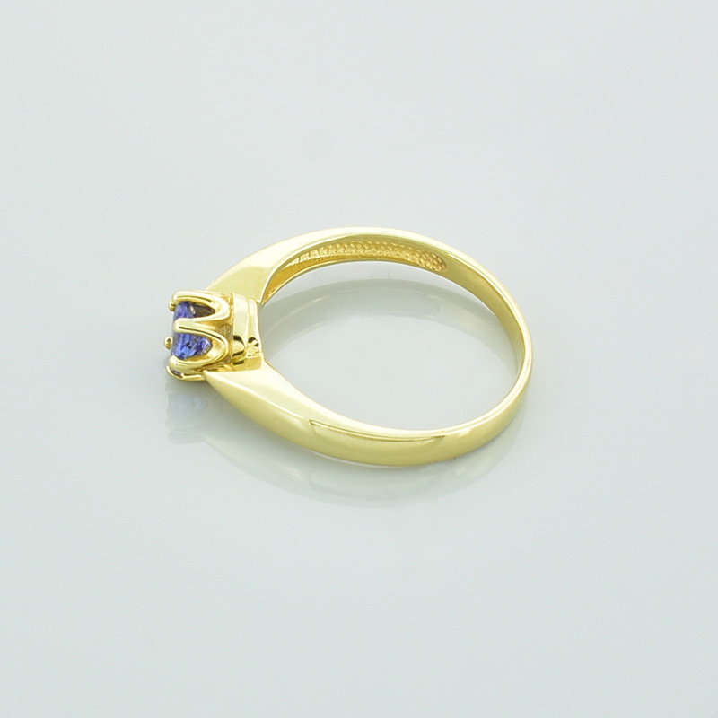 Złoty pierścionek z tanzanitem o niebiesko fioletowej barwie.