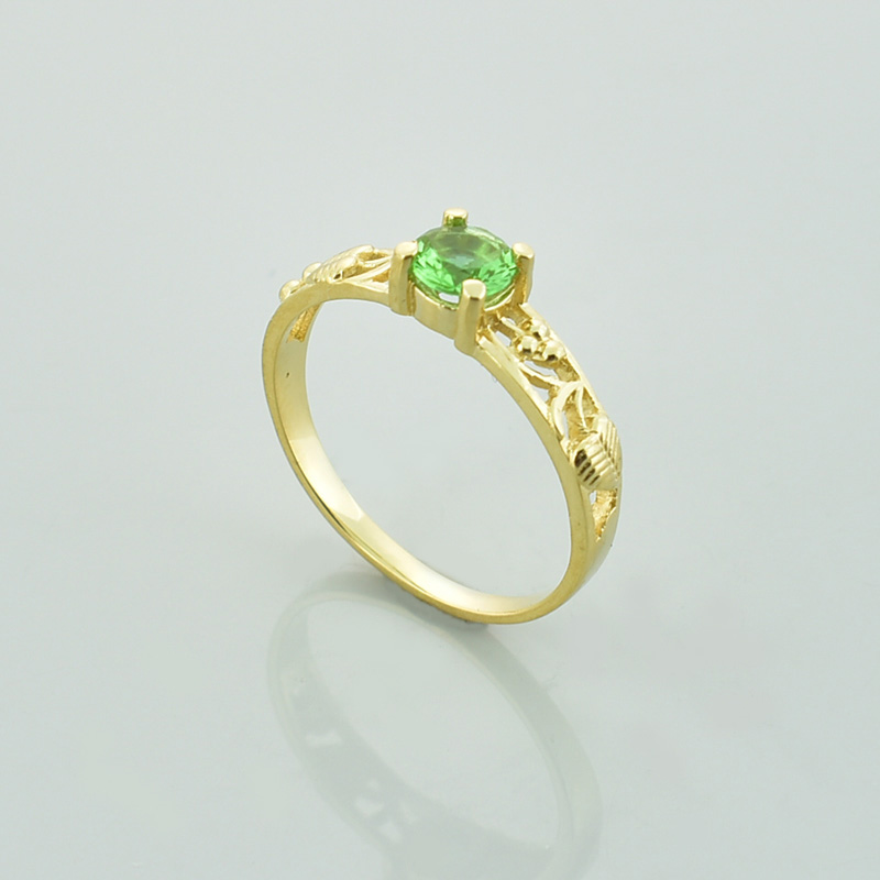 Złoty pierścionek z zielonym sułtanitem i ażurkową obrączką.