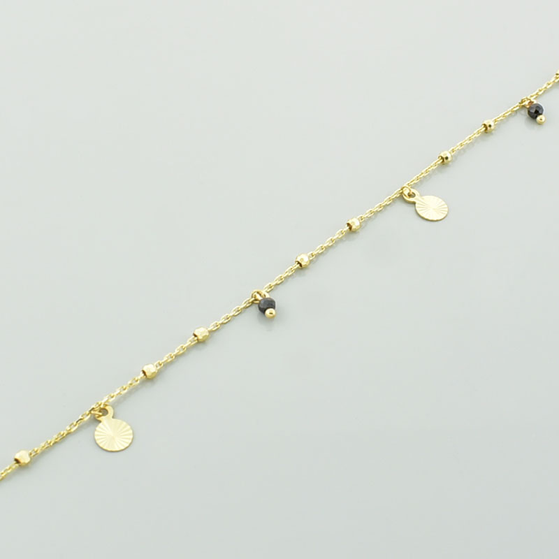 Złota bransoletka łańcuszkowa diamentowana w zbliżeniu.