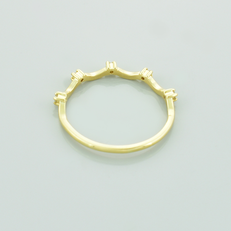 Złoty pierścionek z brylantami fala leżący tyłrm.
